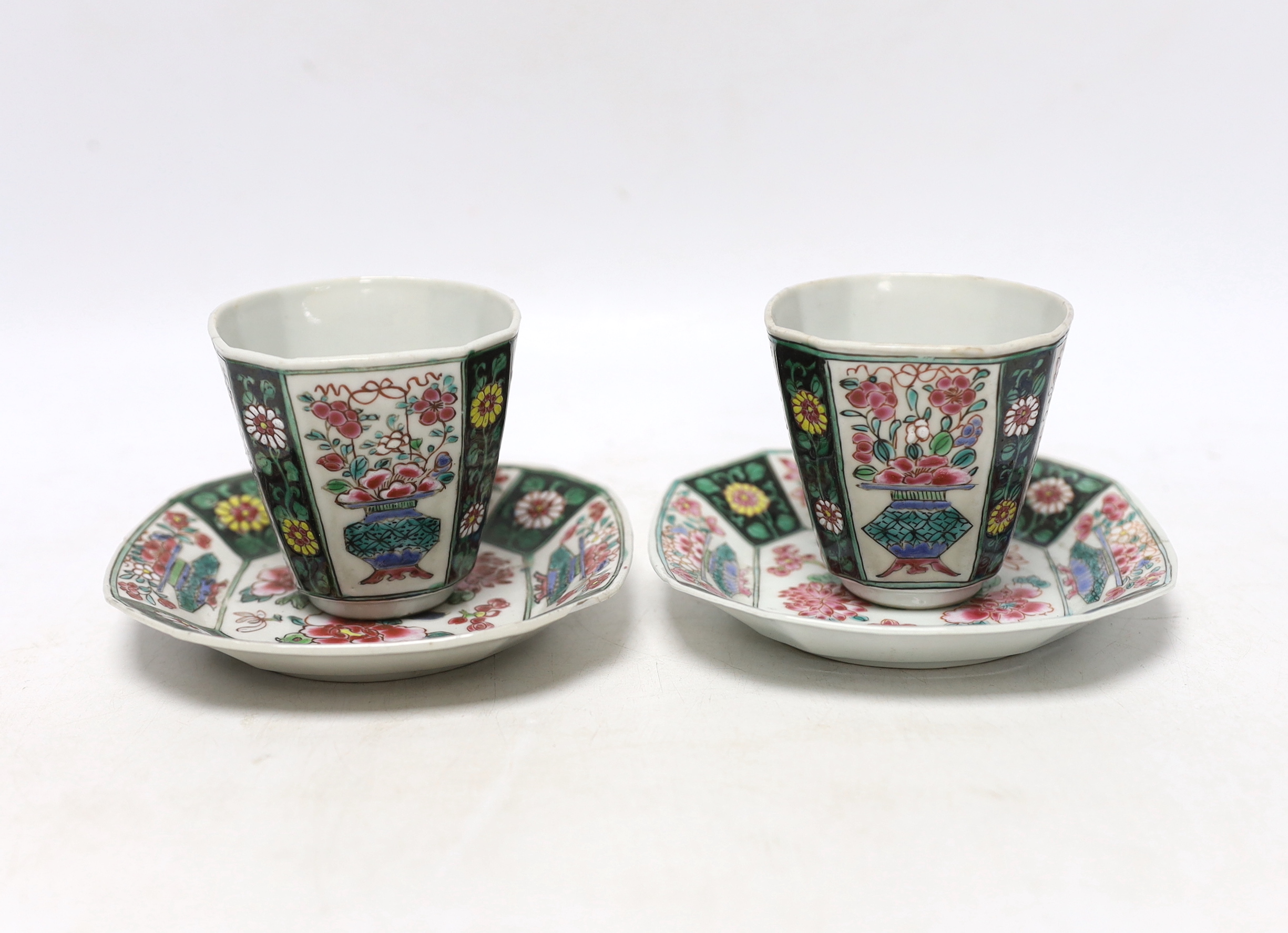 A pair of Chinese Qianlong famille rose octagonal cups and saucers, with panelled floral decoration, saucers 12cm cups height 6.5cm diameter 6.75cm